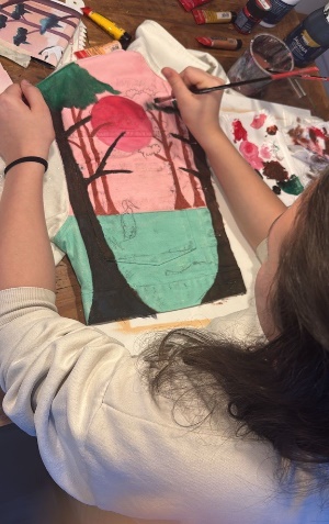 Jana painting fine details on the landscape